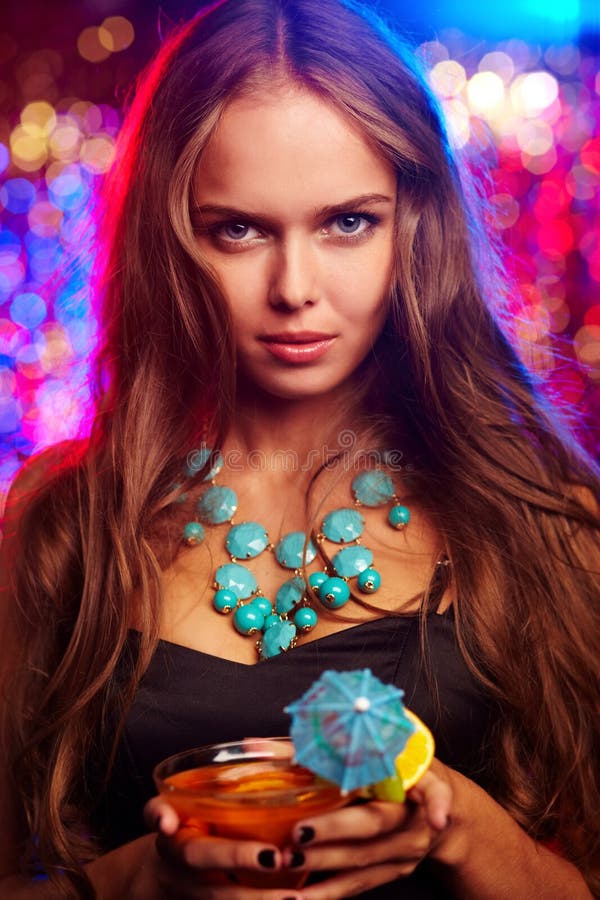 Image of pretty girl with cocktail in the night club. Image of pretty girl with cocktail in the night club