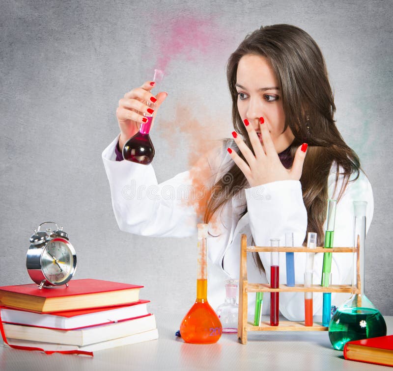 Girl experimenting with colorful chemical liquids. Girl experimenting with colorful chemical liquids