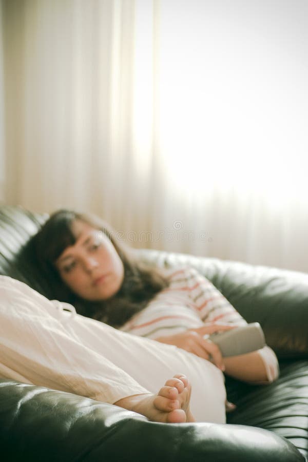 A girl watching TV lonesomely. A girl watching TV lonesomely.