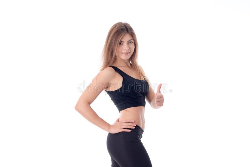 Beautiful athletic girl looks at the camera and is turned sideways with one hand shows class. Beautiful athletic girl looks at the camera and is turned sideways with one hand shows class
