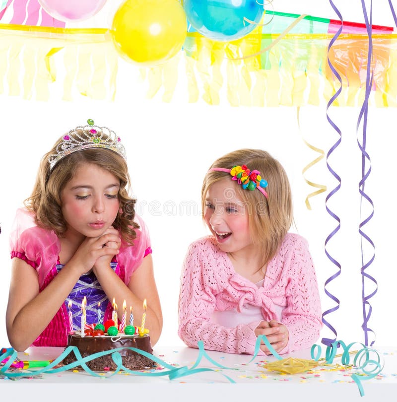 Children happy girls blowing birthday party chocolate cake candles. Children happy girls blowing birthday party chocolate cake candles