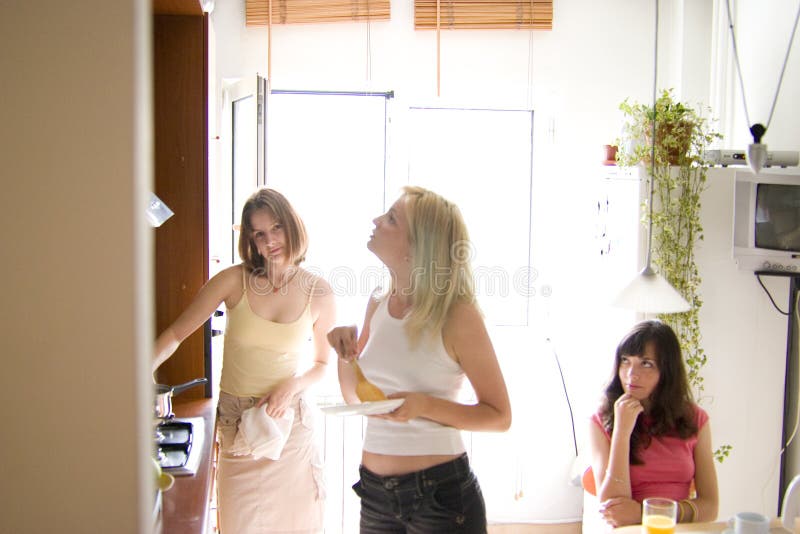 Three girls in the kitchen. Three girls in the kitchen.