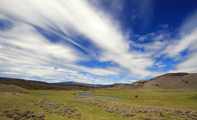 View of Slough Creek under cirrus cumulus clouds in the Lamar Valley of Yellowstone National Park in Wyoming USA. View of Slough Creek under cirrus cumulus clouds in the Lamar Valley of Yellowstone National Park in Wyoming USA