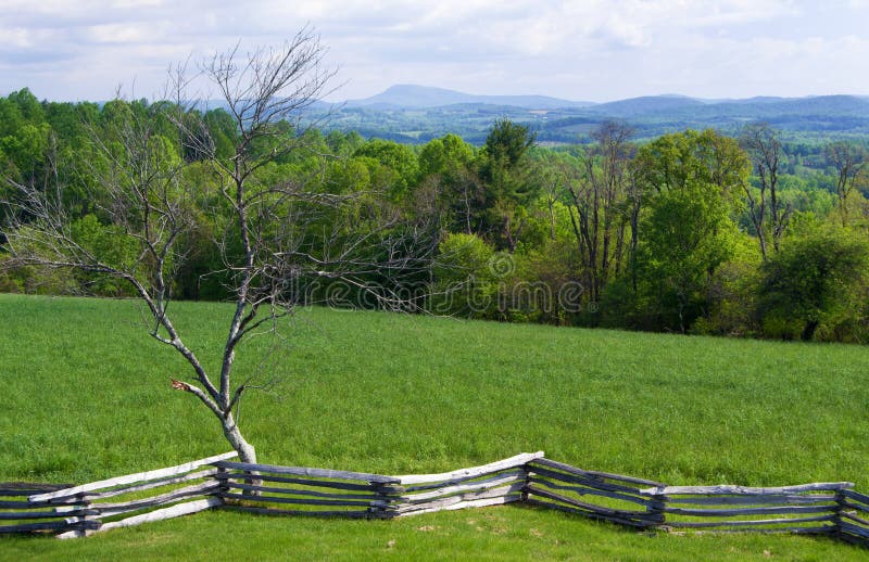 Floyd County, Virginia USA - May 19: View of Buffalo Mountain from Groundhog Mountain picnic area with a snake rail fence in the foreground on the Blue Ridge Parkway on May 19, 2014, Floyd County, Virginia, USA. Floyd County, Virginia USA - May 19: View of Buffalo Mountain from Groundhog Mountain picnic area with a snake rail fence in the foreground on the Blue Ridge Parkway on May 19, 2014, Floyd County, Virginia, USA.