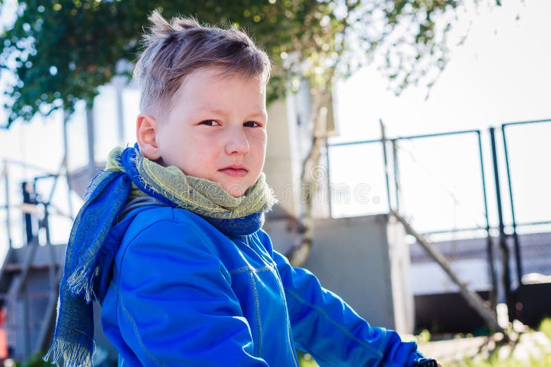 Menino caucasiano de 6 anos de cabelos curtos que olha a câmera fora fotografia de stock Menino caucasiano de 6 anos de cabelos curtos que olha a câmera fora fotografia de stock