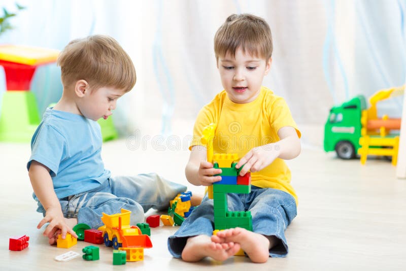 Cute kid boy playing with little brother at home. Cute kid boy playing with little brother at home