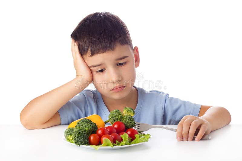 Sad boy doesn't want eat healthy vegetables. Sad boy doesn't want eat healthy vegetables