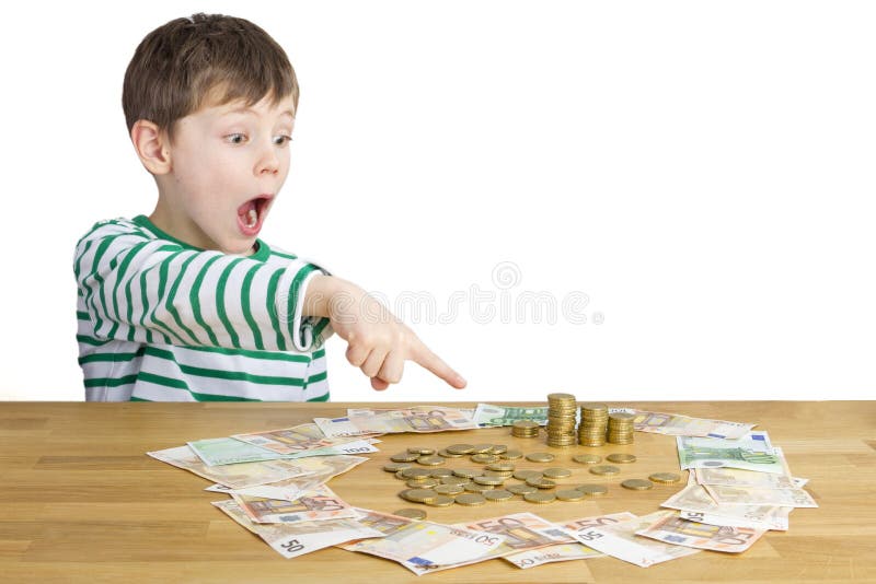 Menino que senta-se na frente de muito dinheiro foto de stock