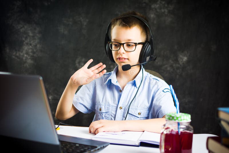 Boy having an online learning class from home on a laptop. Boy having an online learning class from home on a laptop