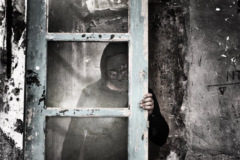 Man behind dirty glass in a spooky dark room. Man behind dirty glass in a spooky dark room