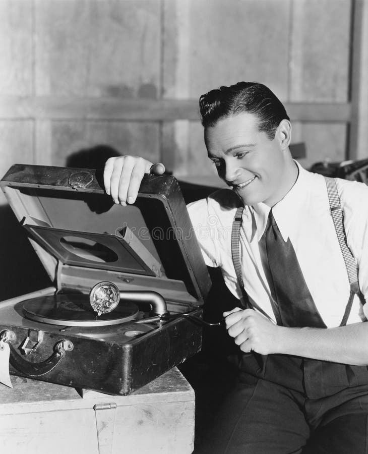 Man listening to record player (All persons depicted are no longer living and no estate exists. Supplier grants that there will be no model release issues.). Man listening to record player (All persons depicted are no longer living and no estate exists. Supplier grants that there will be no model release issues.)