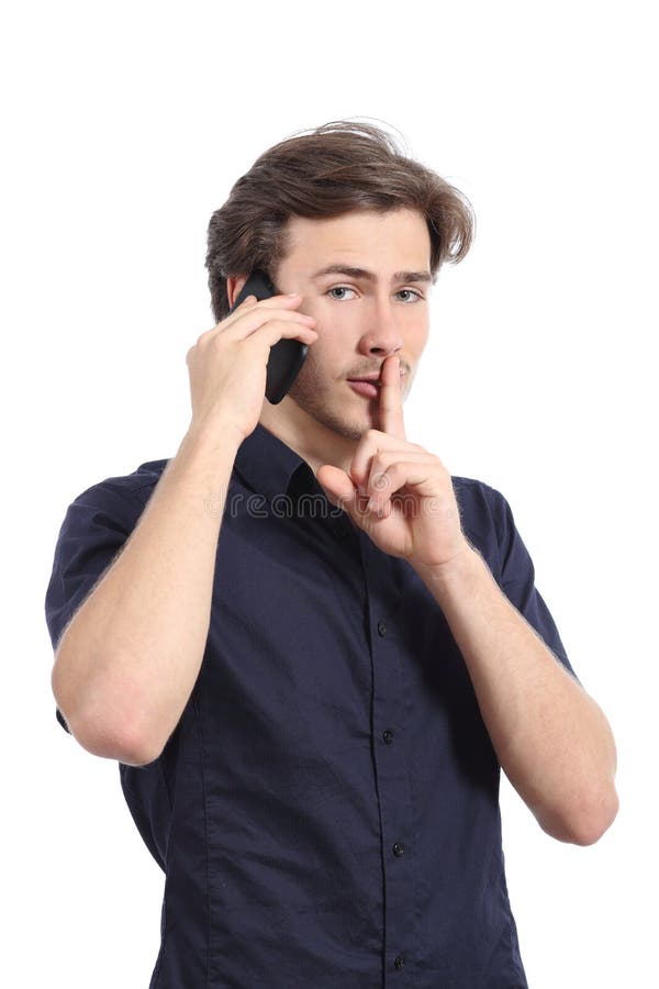 Man asking for silence with finger on lips while is calling on the phone isolated on a white background. Man asking for silence with finger on lips while is calling on the phone isolated on a white background