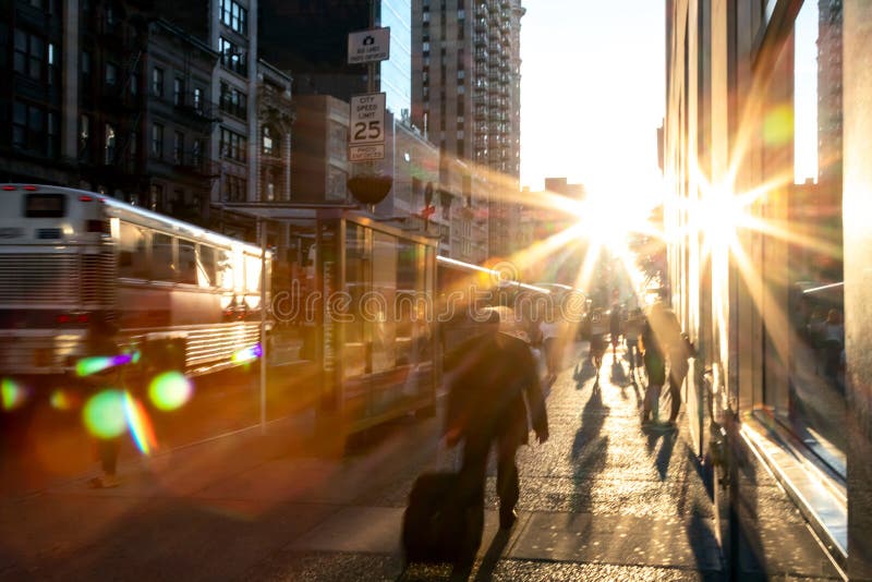 Man rushing down the sidewalk in Manhattan New York City with bright light in the background. Man rushing down the sidewalk in Manhattan New York City with bright light in the background