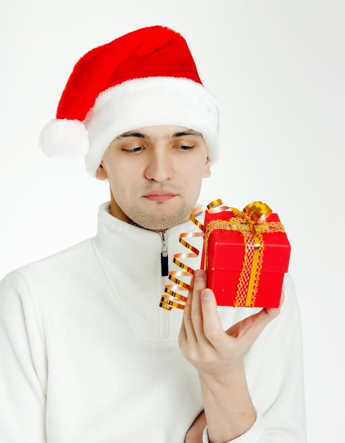 Mens in een Kerstmanhoed met Kerstmisgift royalty-vrije stock afbeelding Mens in een Kerstmanhoed met Kerstmisgift royalty-vrije stock afbeelding