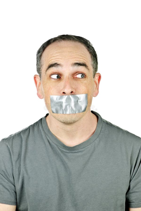 Portrait of man with duct tape over his mouth glancing sideways. Portrait of man with duct tape over his mouth glancing sideways
