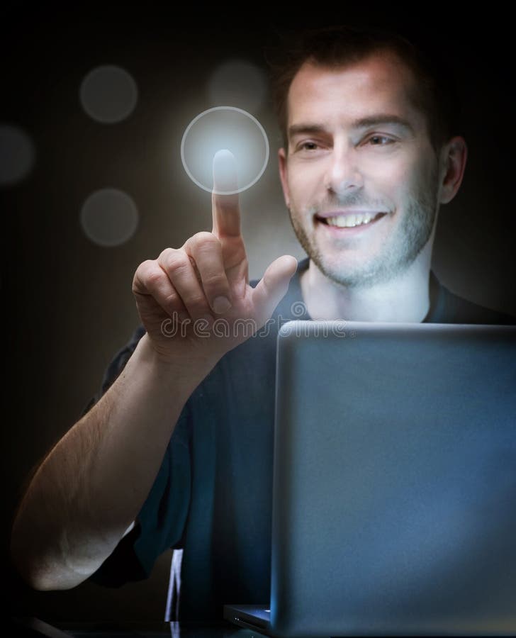 Young Man With Laptop pushing the button. Young Man With Laptop pushing the button