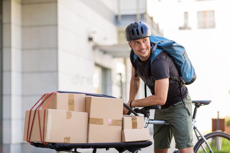 Mensajero de la bici que hace una entrega imagen de archivo libre de regalías Mensajero de la bici que hace una entrega imagen de archivo libre de regalías