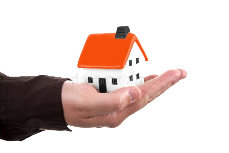 Menschliche Hand, die ein Haus anhält stockbild Menschliche Hand, die ein Haus anhält stockbild