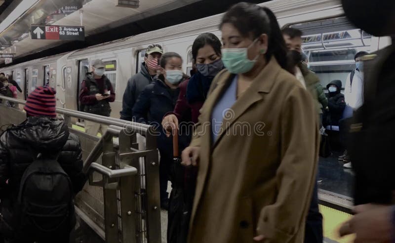 Mensen die gezichtsmasker dragen die de ondergrondse trein naar het werk in New York halen