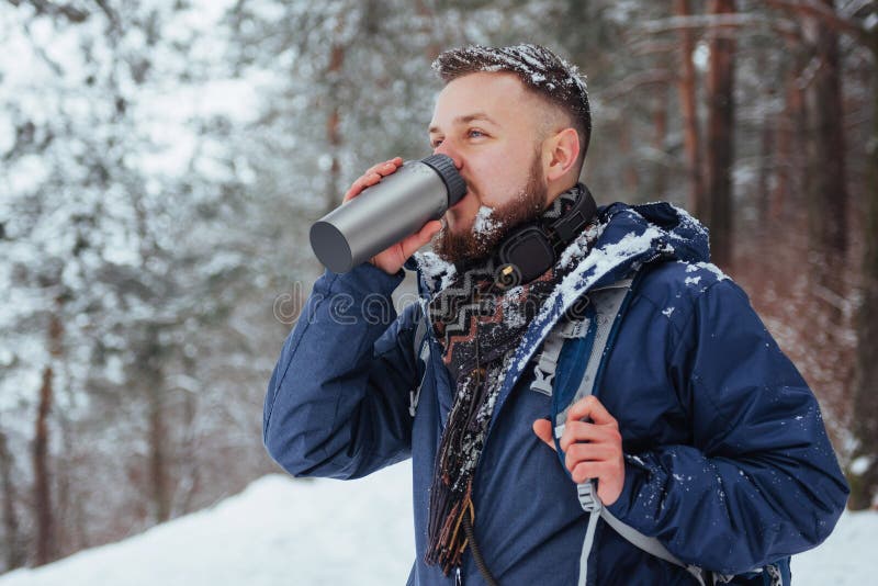 Man Traveler with backpack hiking Travel Lifestyle adventure concept active vacations outdoor. Beautiful landscape with forest of coniferous trees and white snow. Man Traveler with backpack hiking Travel Lifestyle adventure concept active vacations outdoor. Beautiful landscape with forest of coniferous trees and white snow.