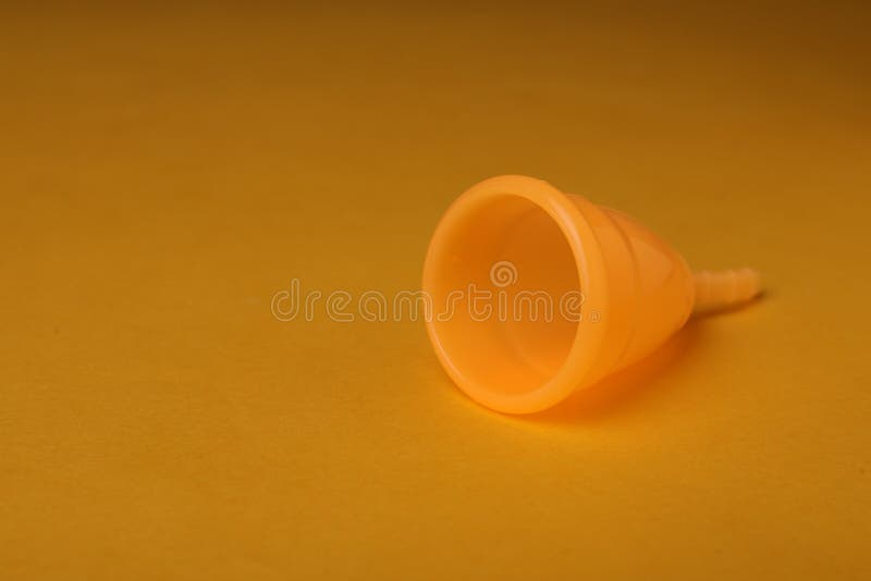 Menstrual Cup on Yellow Background. Space for Text Stock Photo Image