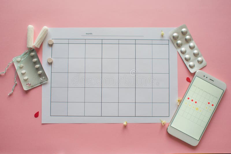 Menstrual cycle. Calendar for the month with marks and a mobile application on the smartphone screen. royalty free stock photos