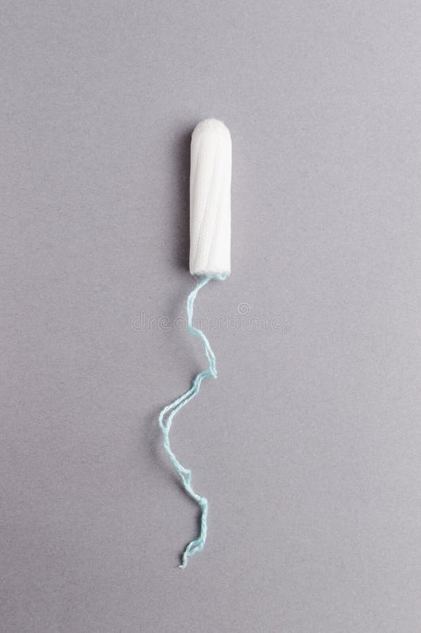 Menstrual Tampon on a Grey Background. Menstruation Time. Hygiene and