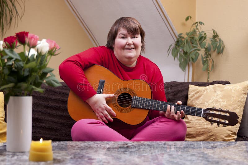 Mentally disabled woman playing guitar royalty free stock image Mentally disabled woman playing guitar royalty free stock image