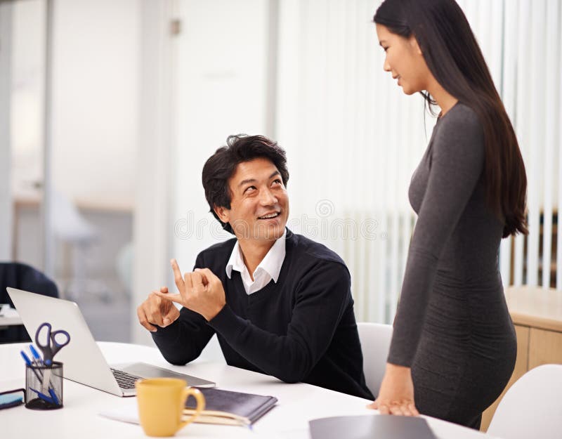 Mentor, help and teamwork on laptop in office with businessman learning from support of woman. Feedback, advice and royalty free stock image
