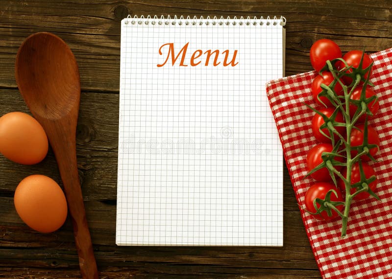 Menu and fresh tomatoes on wooden boards