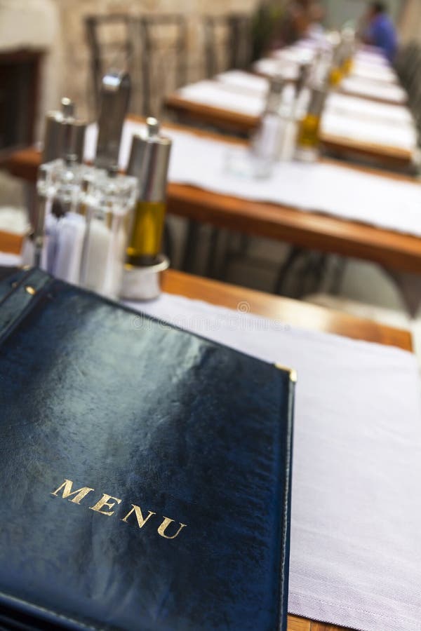 A menu laid on a restaurant table. A menu laid on a restaurant table