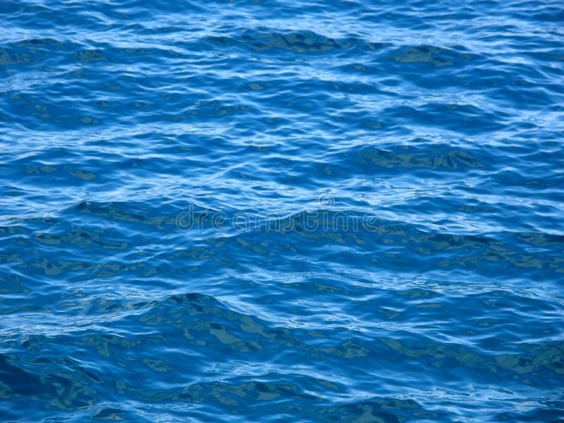 Beautiful texture of a blue waves and ripply at Adriatic sea. Croatia - Dalmatia. Horizontal color photo. Beautiful texture of a blue waves and ripply at Adriatic sea. Croatia - Dalmatia. Horizontal color photo.