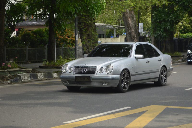 A silver sedan Mercedes Benz W210 E Klasse on the streets in Medan, North Sumatra, Indonesia &#x28;Apr 3, 2024&#x29;.