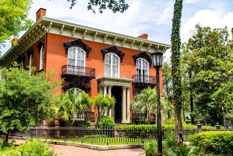 The Mercer Williams house surrounded by trees. The Mercer Williams house surrounded by trees