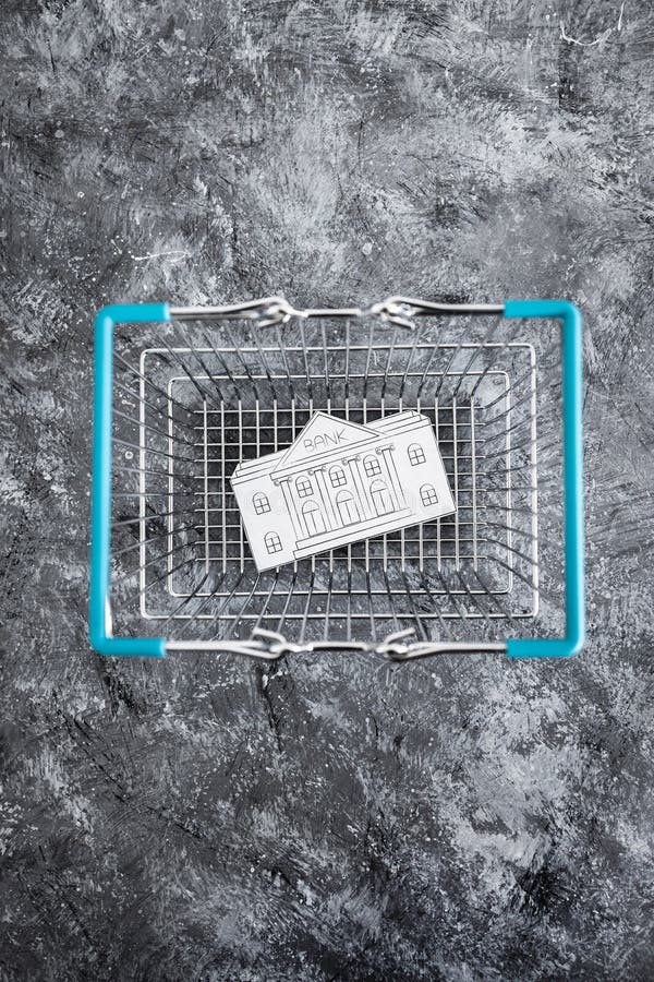 Merging and holdings, bank made of paper inside of shopping basket ready to be bought by a competitor stock photography Merging and holdings, bank made of paper inside of shopping basket ready to be bought by a competitor stock photography