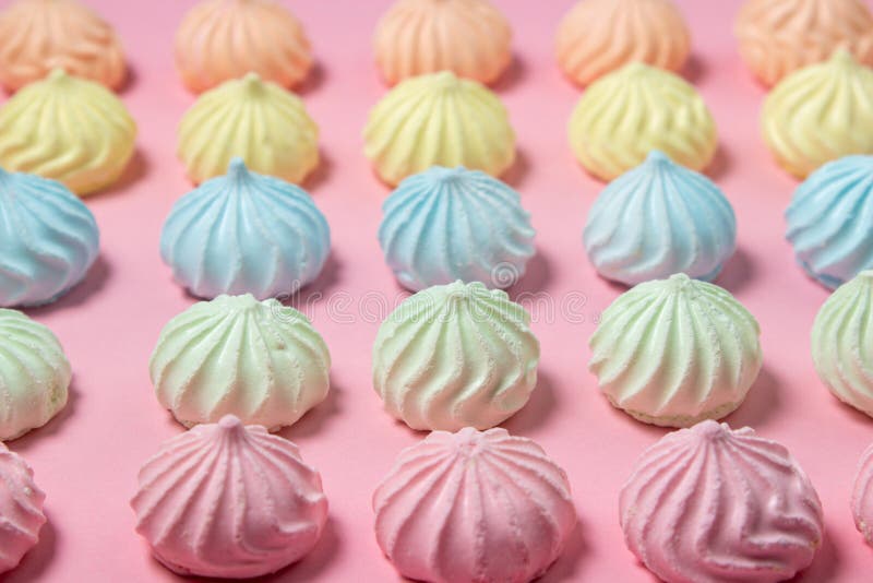Meringue of different colors folded in several rows by color stock photography