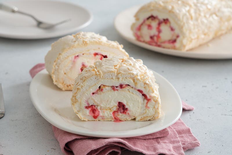 Meringue roll cake with cream, raspberries. Roulade, summer dessert. Confectionery, menu. Close up