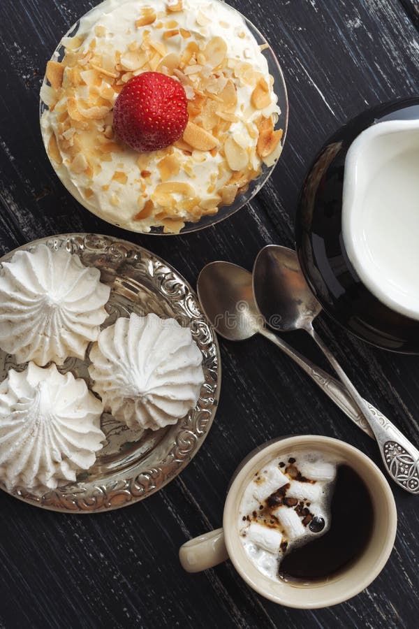 Meringues and dessert with nuts on a wooden dark table, top view. royalty free stock photos Meringues and dessert with nuts on a wooden dark table, top view. royalty free stock photos