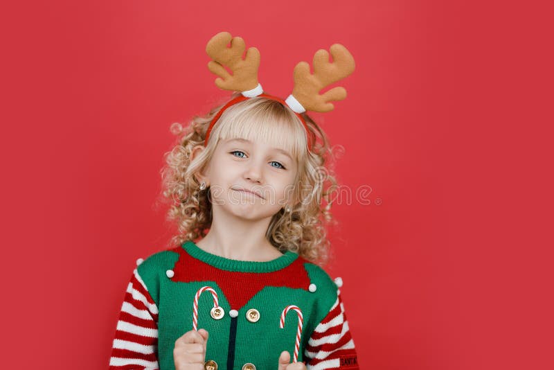 Little Girl In Elf Sweater And Hat Waiting For A Christmas