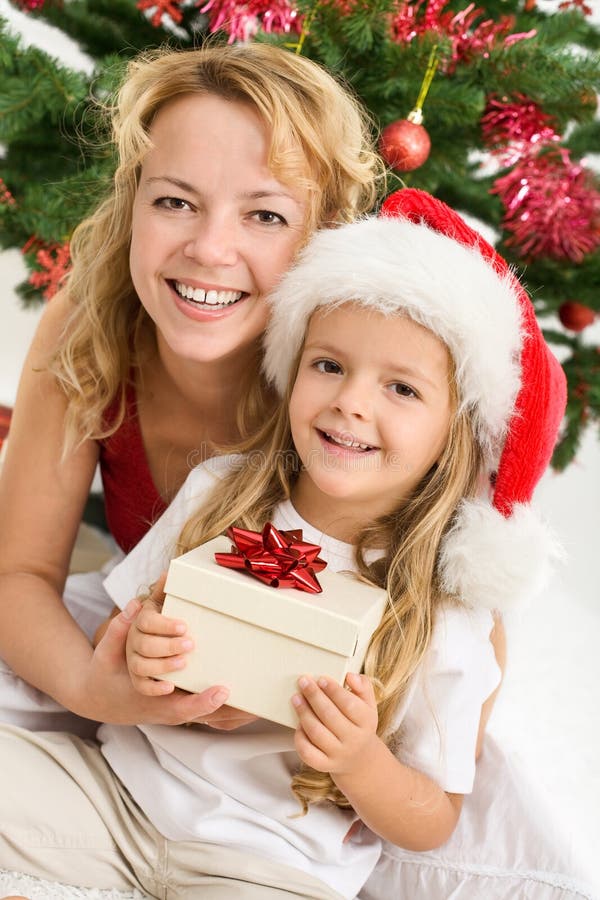 Merry christmas - woman and girl with a present