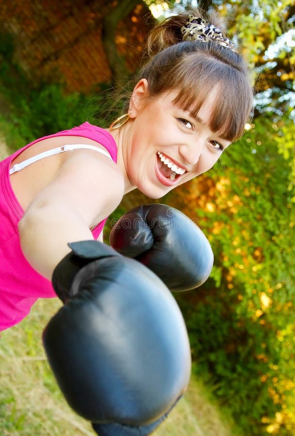 Merry girl in boxing-gloves