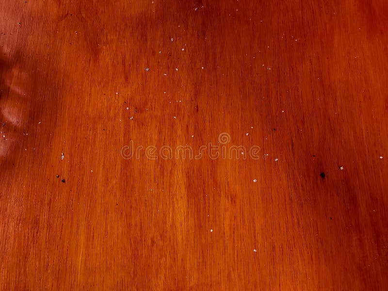 Brown wooden table with little ashes from cigarettes shoot from high angle. Brown wooden table with little ashes from cigarettes shoot from high angle