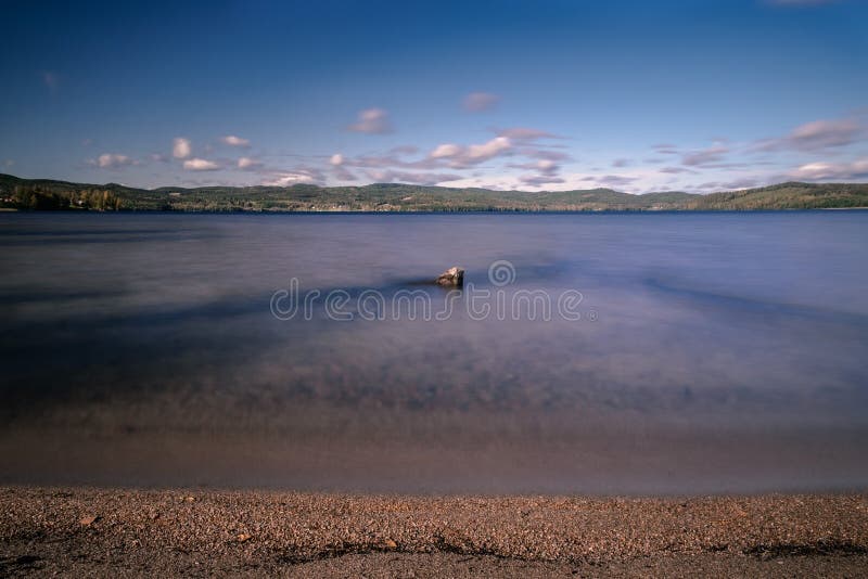 Mesmerizing scenery of a lake in the middle of a forest stock images