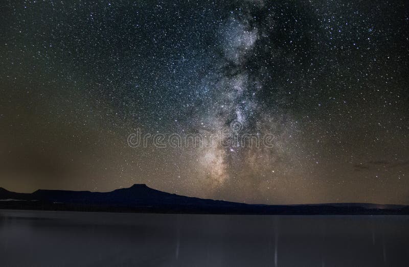 Mesmerizing view of the lake and the mountains under the starry sky in Ghost Ranch, New Mexico royalty free stock photo