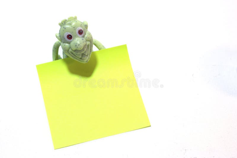 Plastic toy holding the empty message paper. Frog office stock images, royalty-free photos and pictures