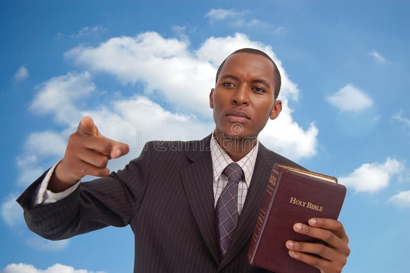 This is an image of man holding a bible against a cloud/sky background. This image can be used to represent Heavenly Message,sermon, preaching etc. This is an image of man holding a bible against a cloud/sky background. This image can be used to represent Heavenly Message,sermon, preaching etc...