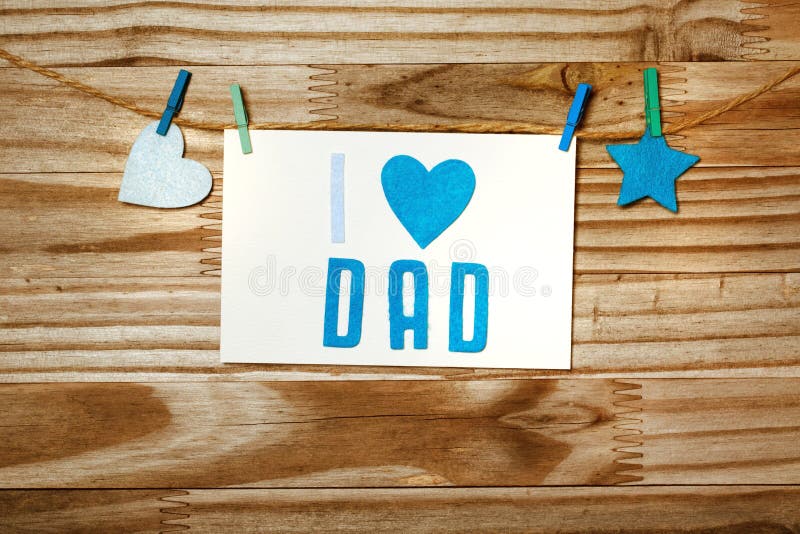 Fathers day message card with felt heart and star hanging with clothespins. Fathers day message card with felt heart and star hanging with clothespins