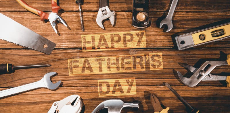 Happy fathers day message surrounded by tools on wooden background. Happy fathers day message surrounded by tools on wooden background