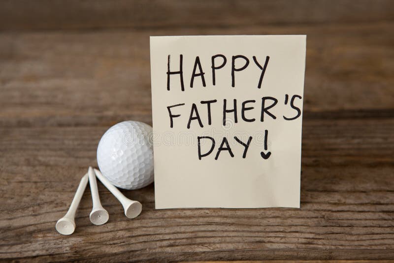 Happy fathers day message with sports equipments on wooden plank. Happy fathers day message with sports equipments on wooden plank