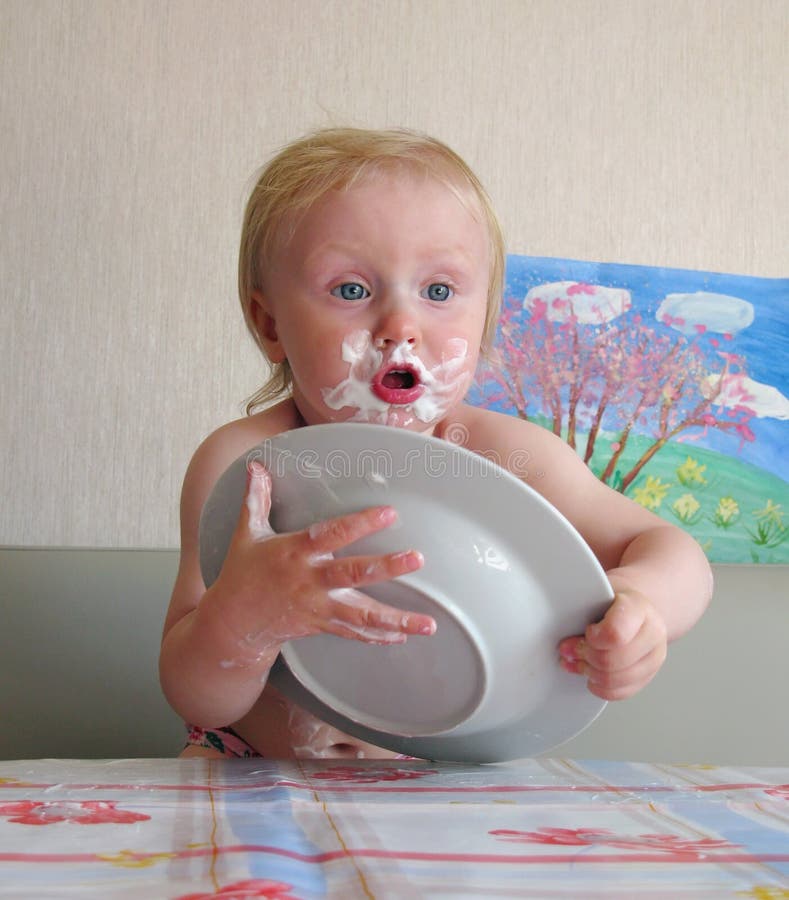 Messy baby with plate royalty free stock photos